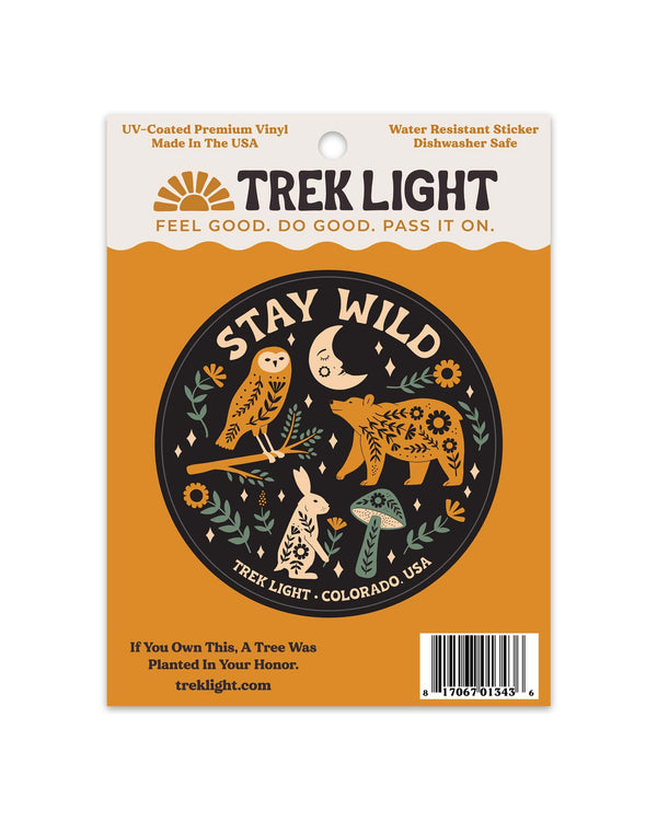 Stay Wild Sticker, a round black vinyl design with an owl, bear, rabbit and mushroom, on orange card on white.