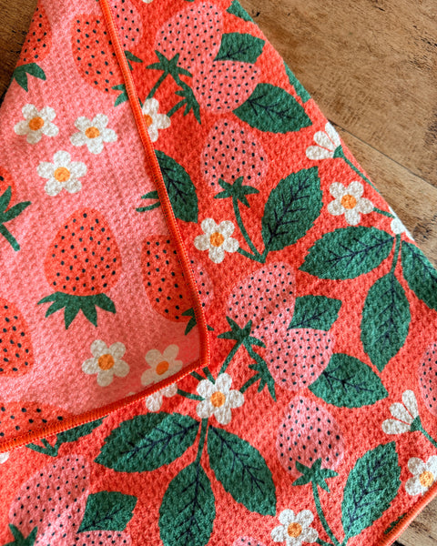 Strawberry Letter Kitchen & Tea Towel with vibrant strawberry and floral design on a textured background.