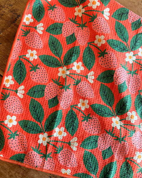 Strawberry Letter Kitchen & Tea Towel featuring vibrant strawberry and flower patterns on a coral background.