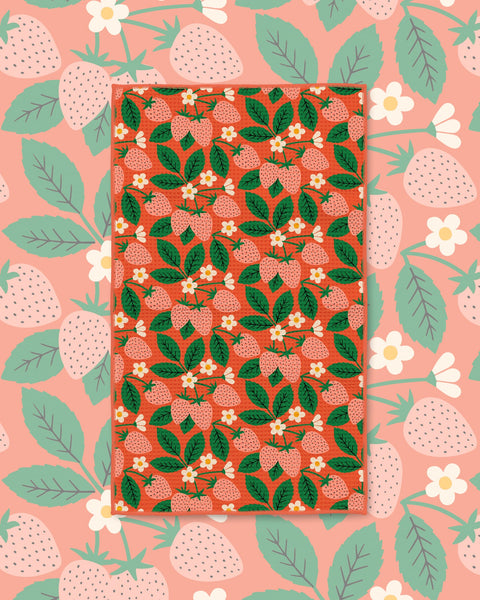 Strawberry Letter Kitchen & Tea Towel with strawberries, white blossoms and green leaves on a red background