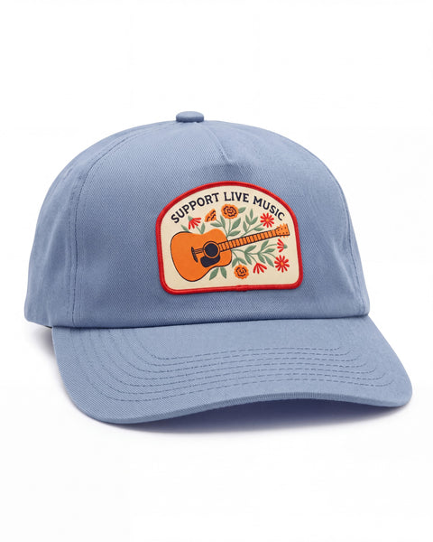Support Live Music Hat in light blue with a lightly curved brim and an embroidered patch of an acoustic guitar and flowers, on white.