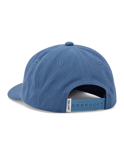 Take Me To The River Hat in blue twill, shown from the back with a snap strap and a small white tag, on white.