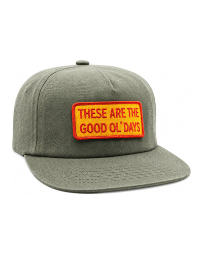 Front of the These Are The Good Ol' Days Hat in olive with a red and yellow patch on a white background, Trek Light
