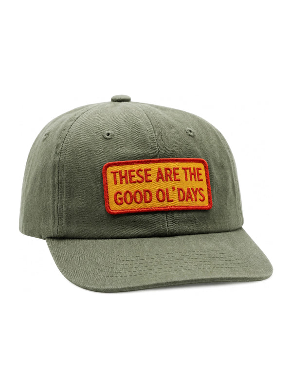 Olive green cap with 'These Are The Good Ol' Days' patch, adjustable fit, ideal for comfort and style, promoting positive vibes.