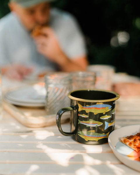 Trout Mug - Enamel 16oz Mug with colorful trout design on table during meal.