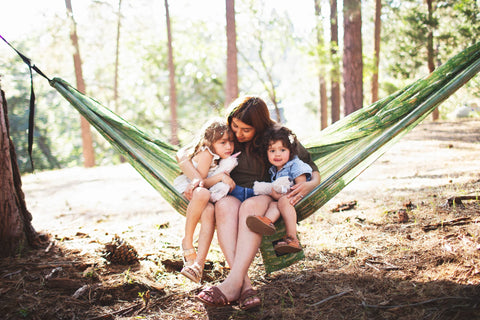 Double Hammock & Pro Hanging Straps (River Trout Print) with a mother and two children enjoying outdoor relaxation.