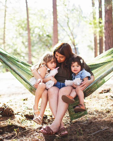 Double Hammock & Pro Hanging Straps (River Trout Print) with a mother and two children enjoying outdoor relaxation.