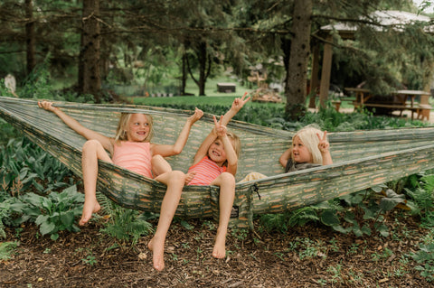 Kids enjoying the Double Hammock & Pro Hanging Straps (River Trout Print) in a backyard setting.