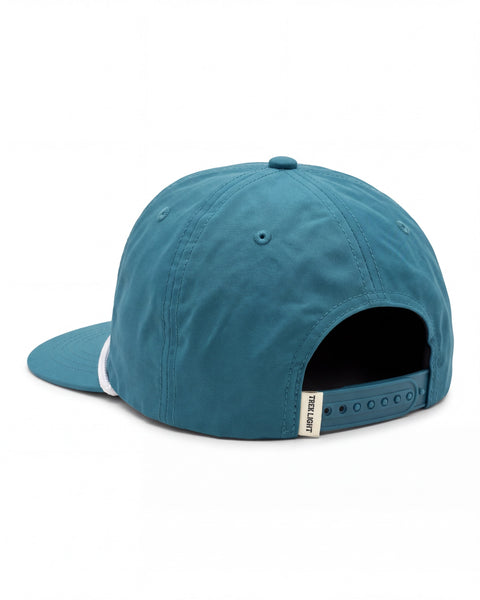 Back view of the Trout Kids Hat, a teal snapback cap with a white cord on the brim and a snap closure, on white.