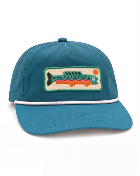 Trout Kids Hat in teal with a white rope band and a stitched green trout patch with an orange sun, on white.