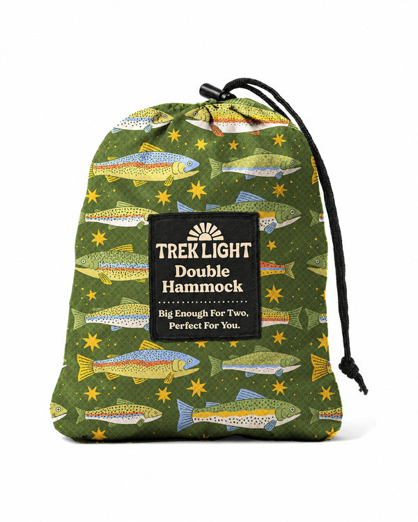 Trout Double Hammock in a green drawstring stuff sack with a colorful trout and gold star print, on white