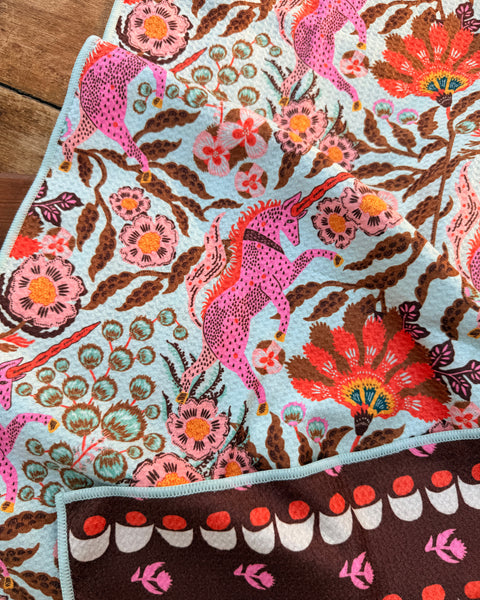 Unicorn Dreams Kitchen & Tea Towel featuring vibrant unicorn and floral designs, eco-friendly, and super absorbent.