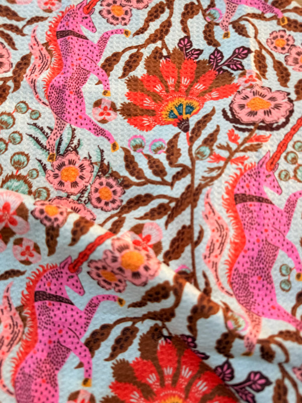Colorful fabric featuring unicorns and flowers on Unicorn Dreams Kitchen & Tea Towel.
