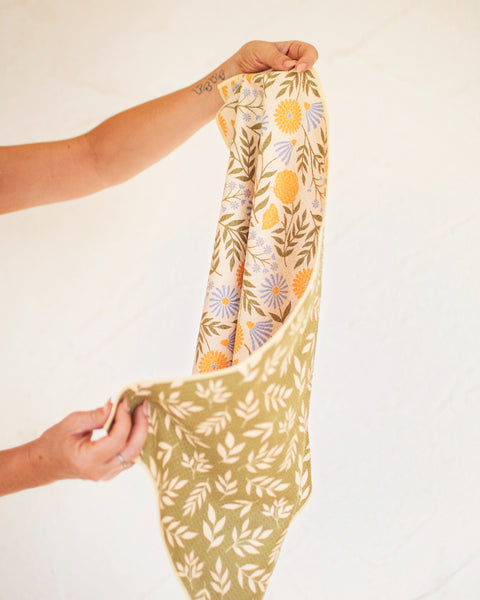 Wavy Flowers Kitchen & Tea Towel displayed with double-sided floral design and vibrant colors, perfect for retro kitchen vibes.