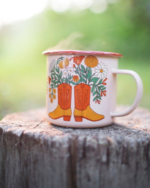 Western Bloom enamel mug 16oz with floral boot design, perfect for adventures. Durable and delightful, by Trek Light.