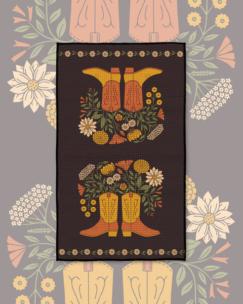 Western Bloom Kitchen & Tea Towel with orange cowboy boots and wildflower bouquets on a dark brown background
