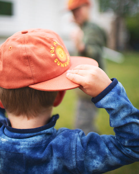 You Are My Sunshine Kids Hat worn by a toddler in a blue fleece jacket outdoors.
