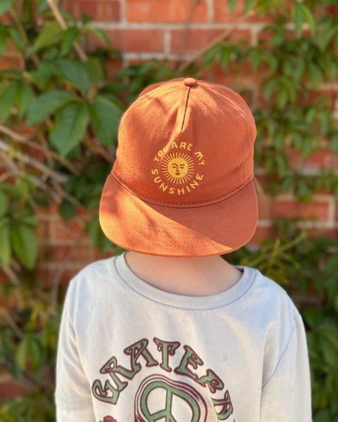 You Are My Sunshine Kids Hat shown on a child, perfect for sunny days and outdoor play.