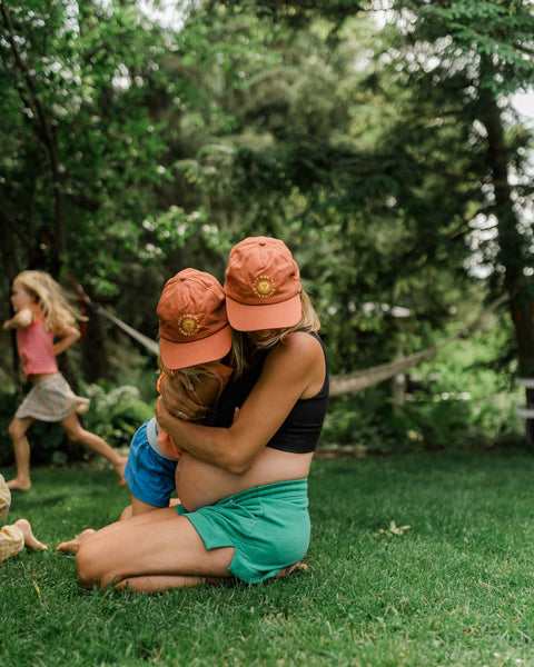 Mother and children wearing You Are My Sunshine Kids Hat, enjoying a sunny day in the park.
