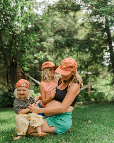 You Are My Sunshine Hat - Twinsie Set featuring a mother and her children wearing matching hats outdoors.