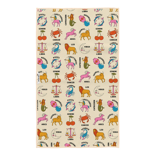 Zodiac tea towel design on cream background featuring zodiac symbols and animals scattered in an allover pattern with detailed illustrations of each astrological sign in rich jewel tones and pastels