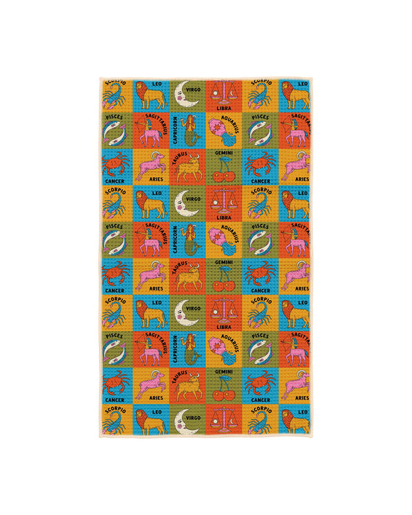 Colorful zodiac kitchen tea towel with repeating pattern of all 12 astrology signs including scorpio, leo, virgo, libra, pisces, sagittarius, cancer, aries, taurus, gemini, and aquarius on bright blue, yellow, orange and green squares