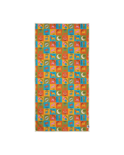 Zodiac travel towel with bright multi-colored grid pattern featuring all 12 astrology signs, animals, and celestial symbols in vibrant orange, blue, yellow, and green