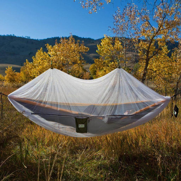 Trek Light Bug Free Hammock Shield in a scenic autumn meadow, keeping bugs away from your peaceful outdoor relaxation.