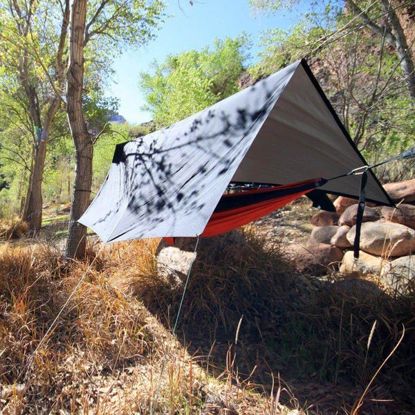 Trek Light V9 Strong Tarp as a hammock rain fly in a wooded area.