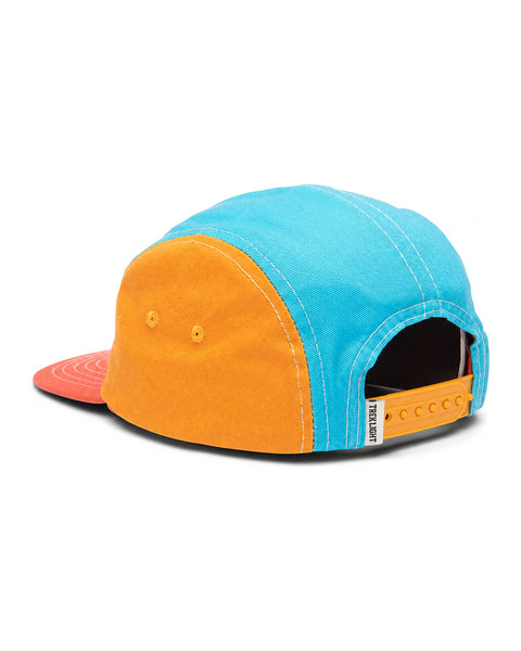 Colorful Happiest Camper Kids Snapback Hat with flat brim, featuring blue, orange, and red panels. Trek Light style for adventurous kids.