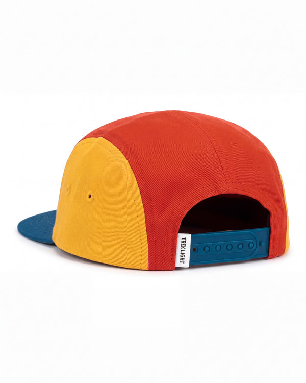 Stay Wild Kids Hat, a five-panel cap in rust red and mustard yellow with a blue brim and snap strap, on white.