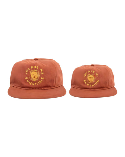 Matching 'You Are My Sunshine' hats set for adults and kids, perfect for twinsie adventures. Matching hats for kids, baby and adults. By Trek Light.