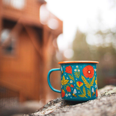 Garden Buzz enamel mug 16oz with a floral and bee design on a rustic background
