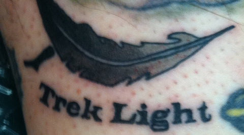 Chad Patzer's tattoo of the original Trek Light feather logo with Trek Light lettering