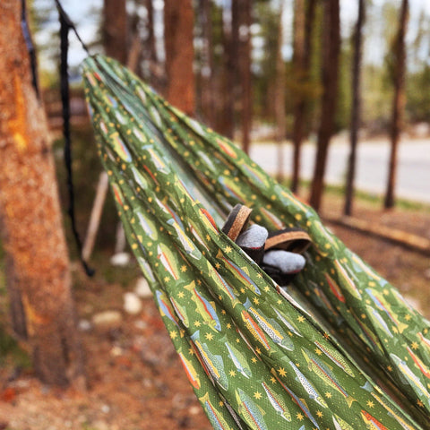 A Trek Light double hammock strung between two trees, ready to hang anywhere