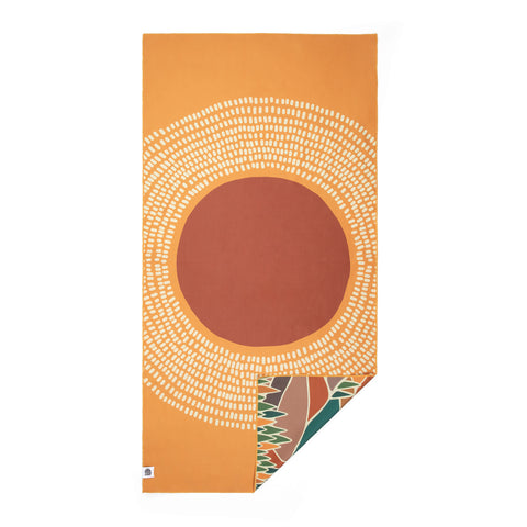 Vibrant orange towel from Trek Light with a circular tribal design, ideal for outdoor adventures and beach days.