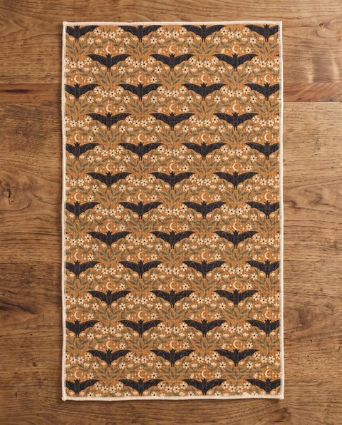 Bats & Blooms waffle kitchen tea towel reverse side laid flat: gold with navy bats and floral vines