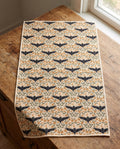 Bats & Blooms waffle kitchen tea towel laid flat on a wood counter showing the full front print