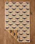 Bats & Blooms waffle kitchen tea towel flat lay with a corner folded up to reveal the reverse print