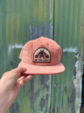 Be The Light Hat shown in hand with a corduroy fabric and embroidered design, perfect for everyday wear.