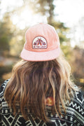 Be The Light hat with painted moth design, 6-panel snapback, flat brim, in a scenic outdoor setting. Trek Light style for all.