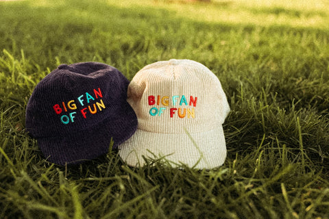 Big Fan Of Fun Hat - Twinsie Set featuring matching corduroy snapback hats for adults and kids in a grassy setting.