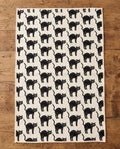 Black Cats waffle kitchen tea towel laid flat on a wood counter showing the full front print