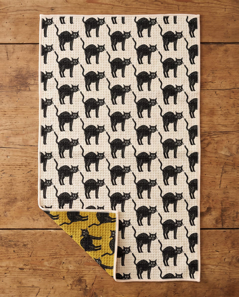 Black Cats waffle kitchen tea towel flat lay with a corner folded up to reveal the reverse print