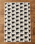 Black Cats waffle kitchen tea towel laid flat on a wood counter showing the full front print