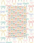 Holiday Bows Kitchen & Tea Towel with colorful hand-drawn bows in red, green, blue and pink on cream