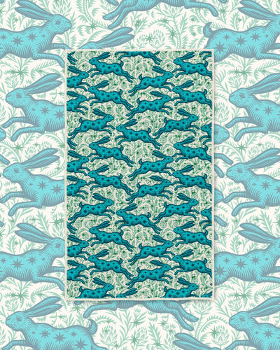 Bunnies On Parade Kitchen & Tea Towel with leaping teal hares on a pale green background