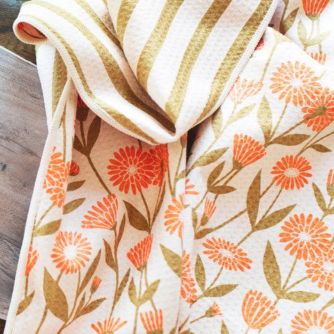 Calendula Flowers Kitchen & Tea Towel featuring vibrant floral and striped designs, eco-friendly and super absorbent.