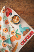California Kitchen & Tea Towel with vibrant designs of California's nature and a latte on a rustic table.
