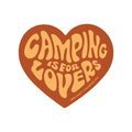 Heart-shaped 'Camping Is For Lovers' sticker by Trek Light, brown text on beige background. Durable, weatherproof, USA-made vinyl sticker.